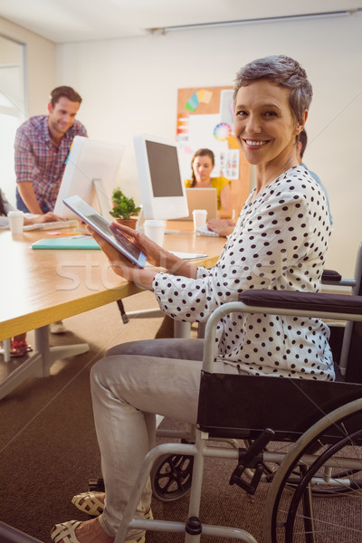 Creative businesswoman in wheelchair using a tablet Stock photo © wavebreak_media