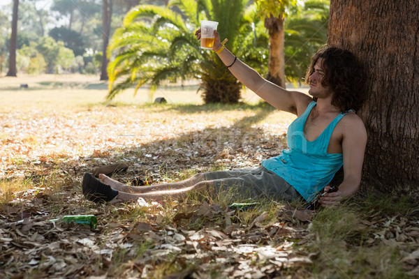 Unconscious man having beer in the park Stock photo © wavebreak_media