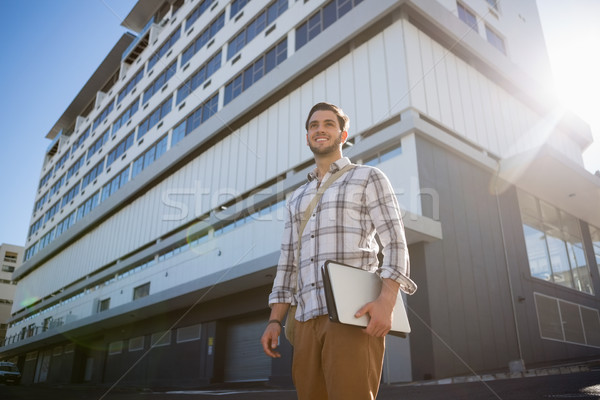 Smiling thoughtful man looking away in city Stock photo © wavebreak_media