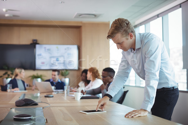 Businessman using digital tablet on desk Stock photo © wavebreak_media