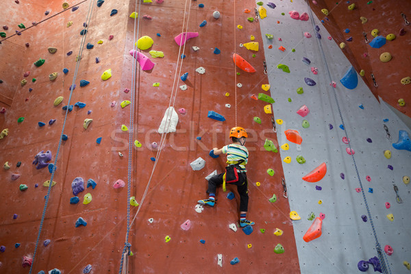 Boy practicing rock climbing in fitness studio Stock photo © wavebreak_media