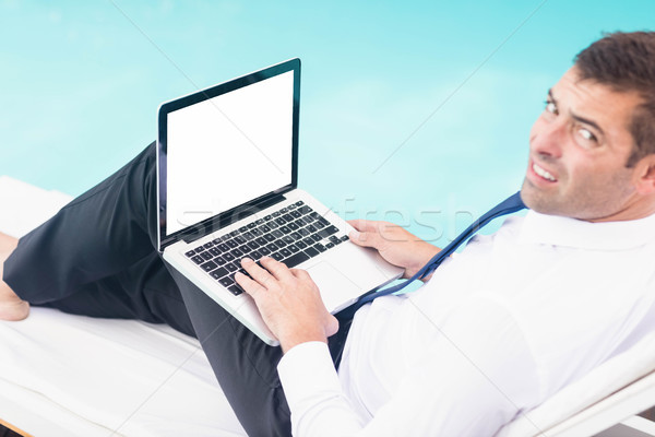 Smarty dressed man using laptop Stock photo © wavebreak_media