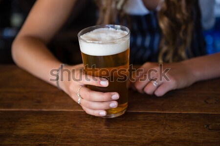 Mid section of man with glass of beer using mobilephone Stock photo © wavebreak_media