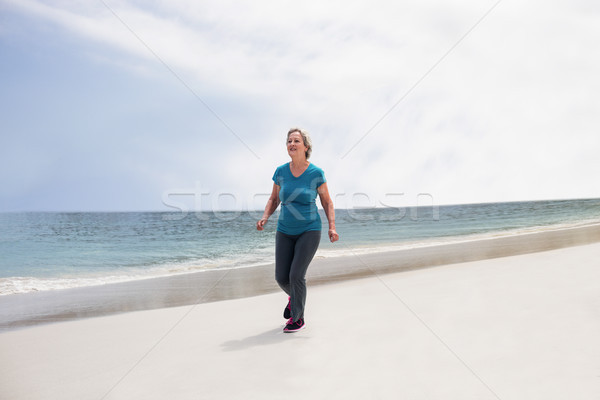 Idős nő jogging tengerpart napos idő óceán Stock fotó © wavebreak_media