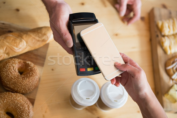 Woman making payment through NFC Stock photo © wavebreak_media