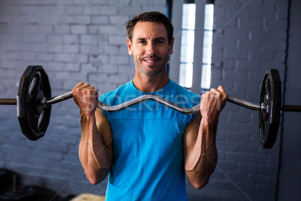 Glimlachend man barbell portret fitness Stockfoto © wavebreak_media