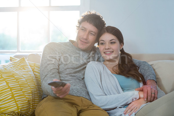 Couple watching television while sitting on sofa Stock photo © wavebreak_media