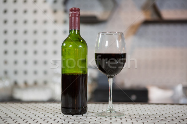 Glass of red wine and bottle on counter Stock photo © wavebreak_media