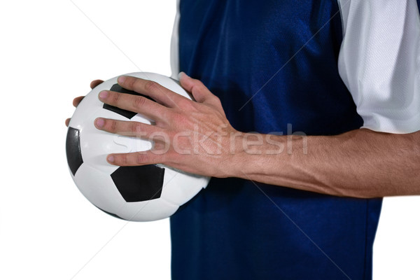 Mid-section of football player holding football with both hands Stock photo © wavebreak_media