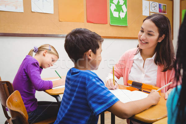 Happy teacher helping her students Stock photo © wavebreak_media