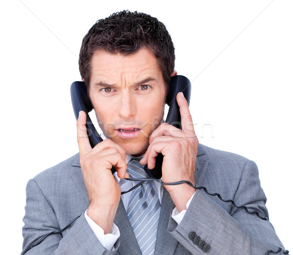 Stock photo: Upset businessman tangle up in phone wires