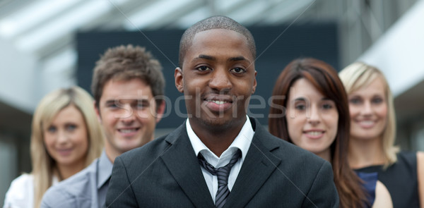 Stock photo: Afro-American businessman smiling at the camera with his team 