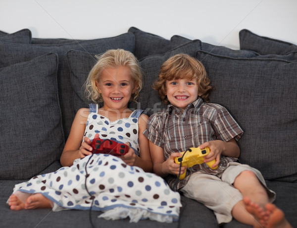 Cheerful children playing video games at home Stock photo © wavebreak_media
