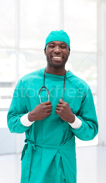 Surgeon holding a stethoscope wearing green scrubs Stock photo © wavebreak_media