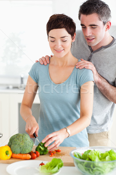 Husband watching his wife cutting vegetables in a kitchen Stock photo © wavebreak_media