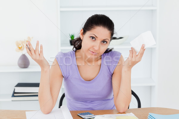 An unenthusiastic young woman is accounting Stock photo © wavebreak_media