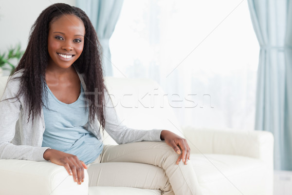 Gülümseyen kadın oturma kanepe bacaklar katlanmış dinlenmek Stok fotoğraf © wavebreak_media