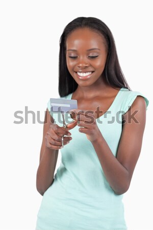 Angry woman destroying her credit card against a white background Stock photo © wavebreak_media