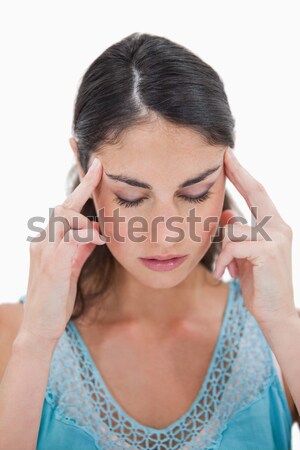 Portrait of a young woman having a headache against a white background Stock photo © wavebreak_media