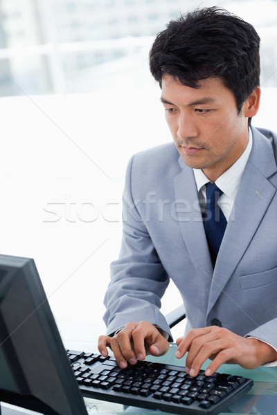 Portrait of a serious manager using a computer in his office Stock photo © wavebreak_media