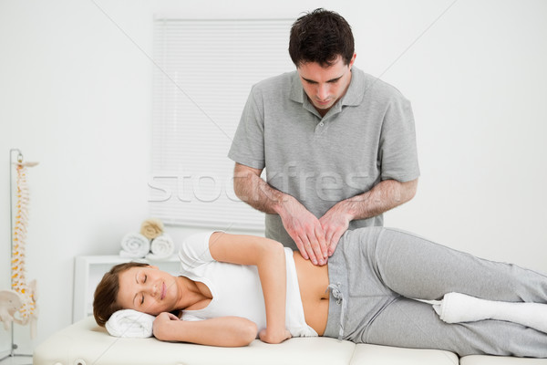 Peaceful woman being massaged on her hip by a doctor in a medical room Stock photo © wavebreak_media
