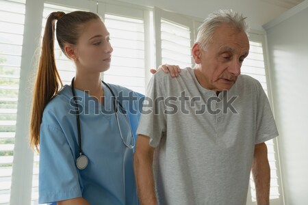 Nurse and a patient standing in hospital ward Stock photo © wavebreak_media