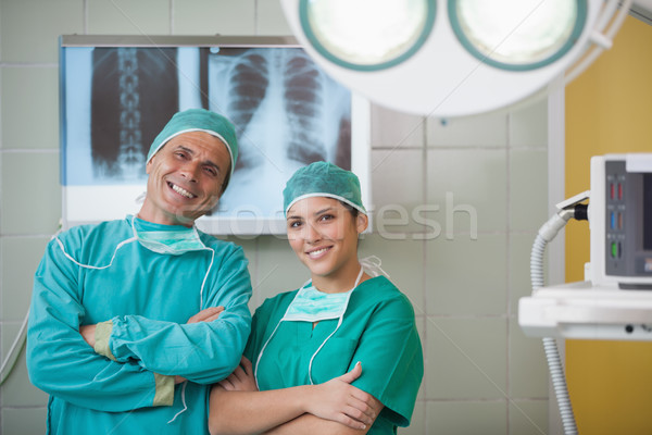 Surgeon and a nurse looking at camera in operating theater Stock photo © wavebreak_media