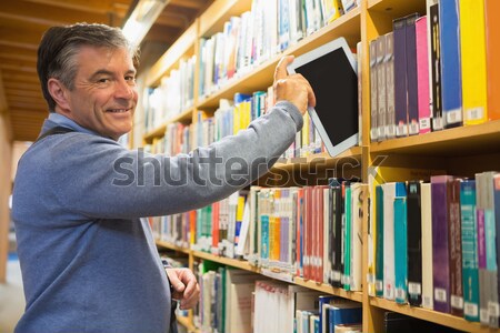 Férfi táblagép polcok könyvtár könyvek diák Stock fotó © wavebreak_media
