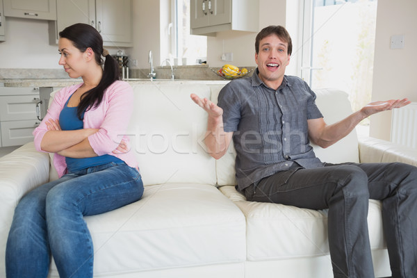 Stock photo: Two people sitting on the couch in the living room fighting
