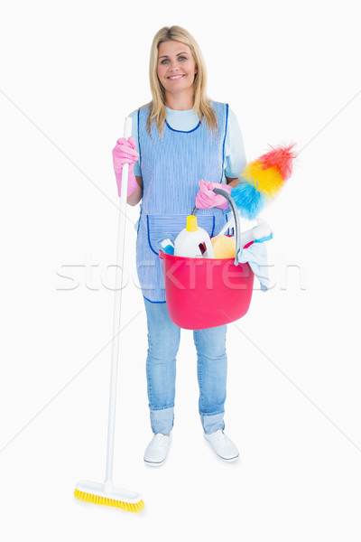 Happy maid holding a pink bucket in the white background Stock photo © wavebreak_media
