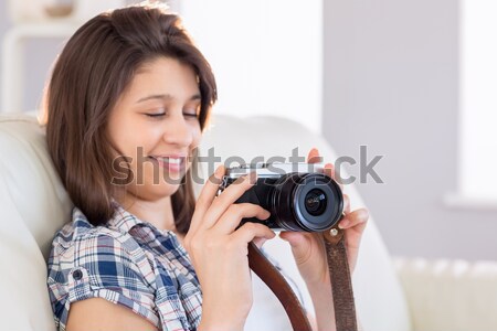Portrait of happy young female with photographic camera Stock photo © wavebreak_media