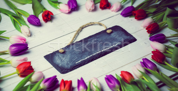 Tulips forming frame around chalkboard Stock photo © wavebreak_media