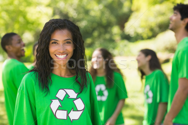 Smiling woman wearing green recycling t-shirt in park Stock photo © wavebreak_media