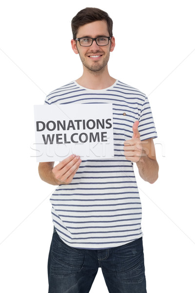 Man holding a donation welcome note while gesturing thumbs up Stock photo © wavebreak_media