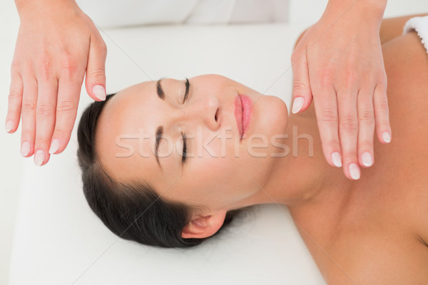 Peaceful brunette getting reiki therapy Stock photo © wavebreak_media