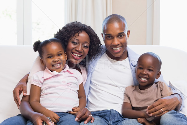 Happy family smiling at camera together Stock photo © wavebreak_media