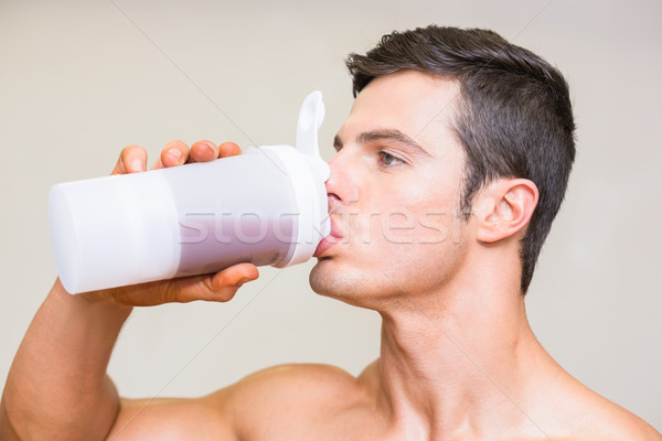 Közelkép sportos fiatalember iszik fehérje fehér Stock fotó © wavebreak_media