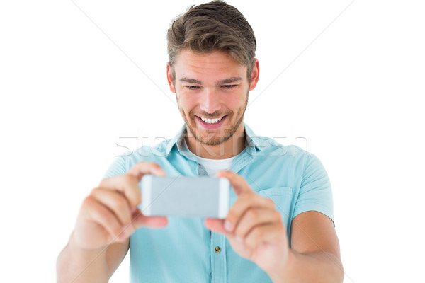 Knap jonge man foto smartphone witte Stockfoto © wavebreak_media