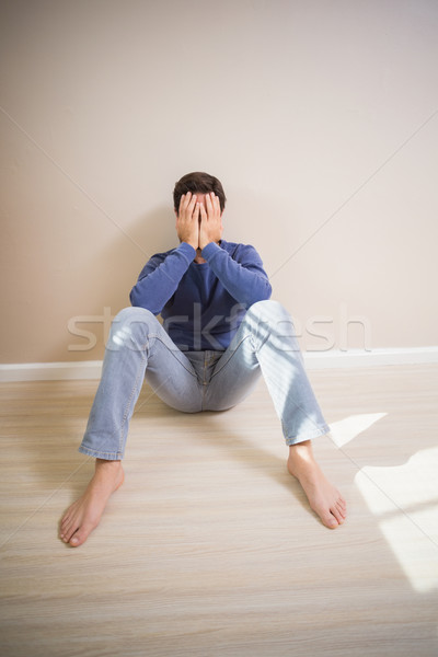 Depressed man sitting on floor Stock photo © wavebreak_media