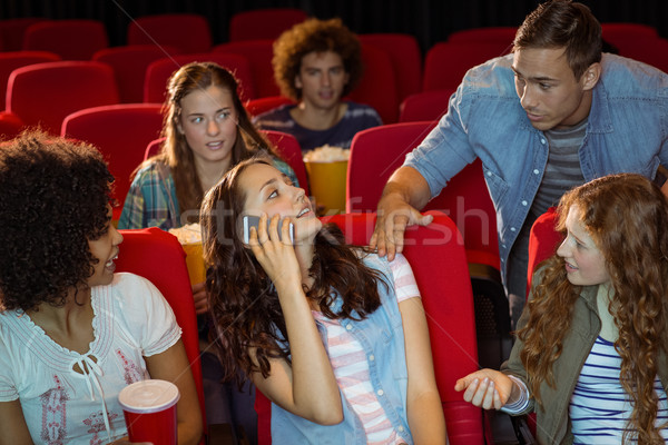 Stock photo: Annoying woman on the phone during movie