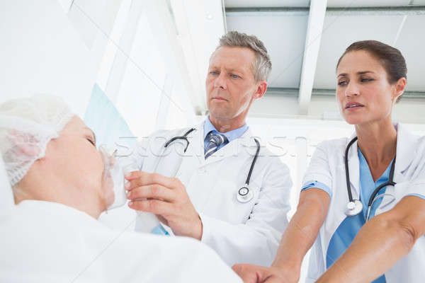 Doctor putting an oxygen mask Stock photo © wavebreak_media