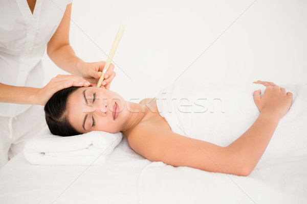 Beautiful woman receiving ear candle treatment at spa center Stock photo © wavebreak_media
