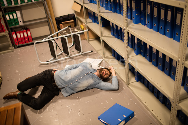 High angle view of fallen businessman and file in storage room  Stock photo © wavebreak_media