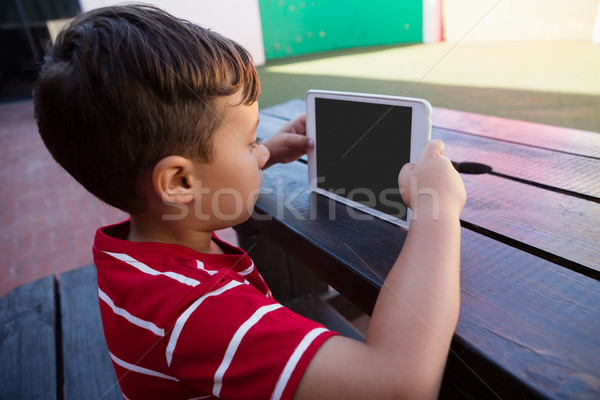 Side view of cute boy holding digital tablet Stock photo © wavebreak_media