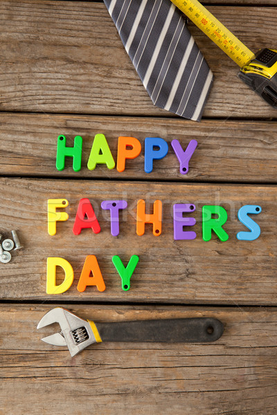 Happy fathers day text by necktie and work tools on table Stock photo © wavebreak_media