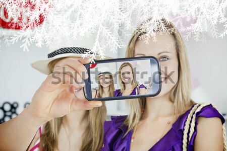 Smiling woman with friends taking selfie at campsite Stock photo © wavebreak_media