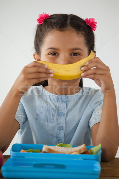 Schoolgirl having breakfast against white background Stock photo © wavebreak_media