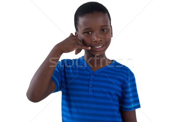 Cute boy pretending to talk on a cell phone Stock photo © wavebreak_media