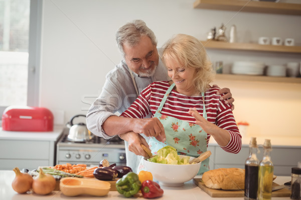 Senior couple mixing vegetables salad in bowl Stock photo © wavebreak_media