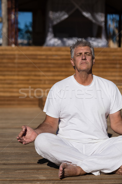 Stock photo: Man practicing yoga on wooden plank